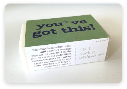 A photo of one of our bars of soap with its affirmation label affixed.